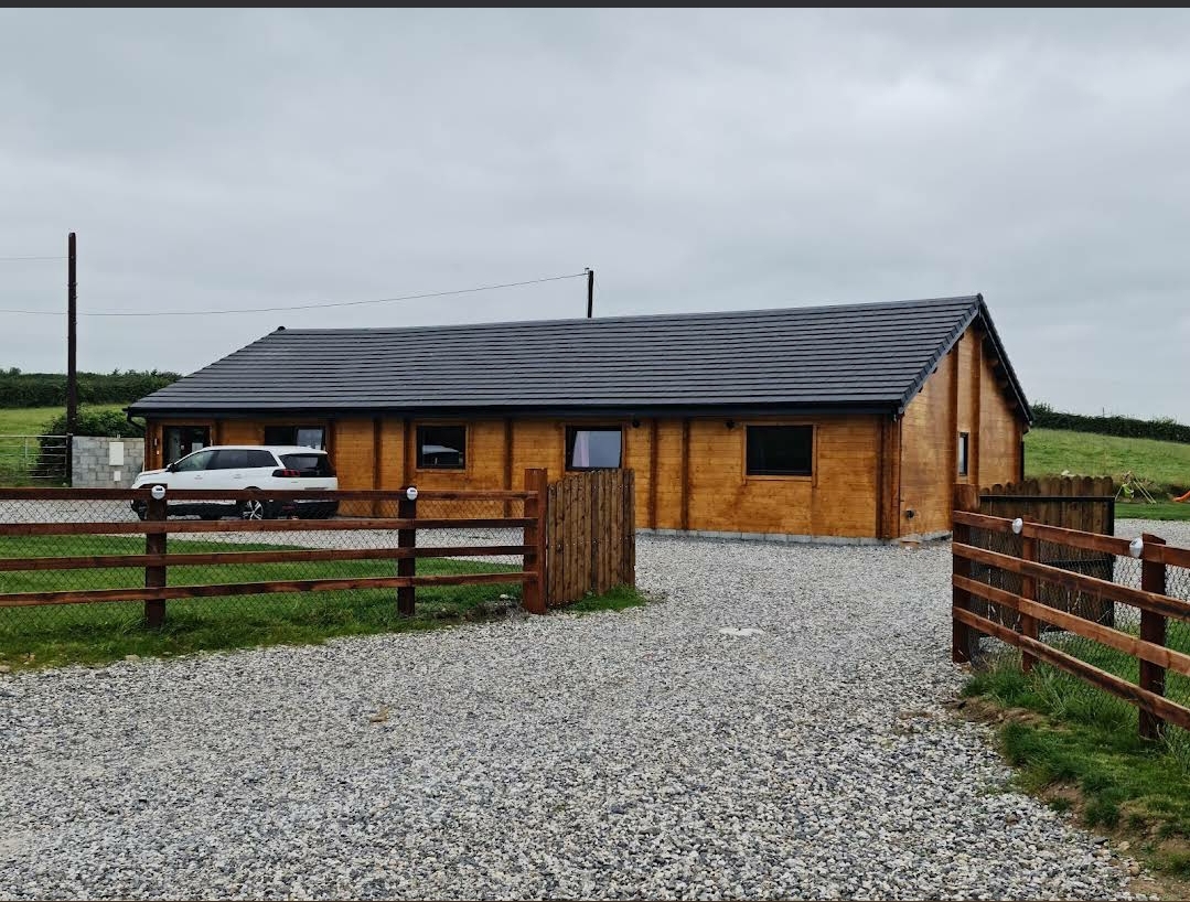 A modular home in Kilkenny with a gravel driveway and car parked in front.